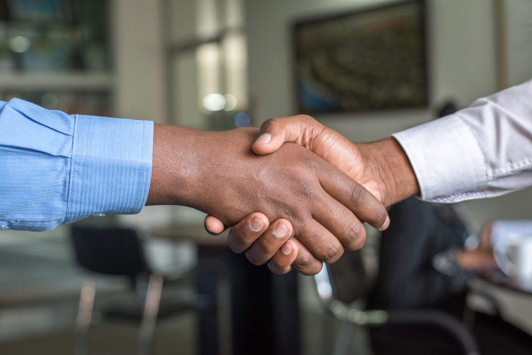 Business partners shaking hands representing commercial real estate partnership buyout and co-owner dispute resolution