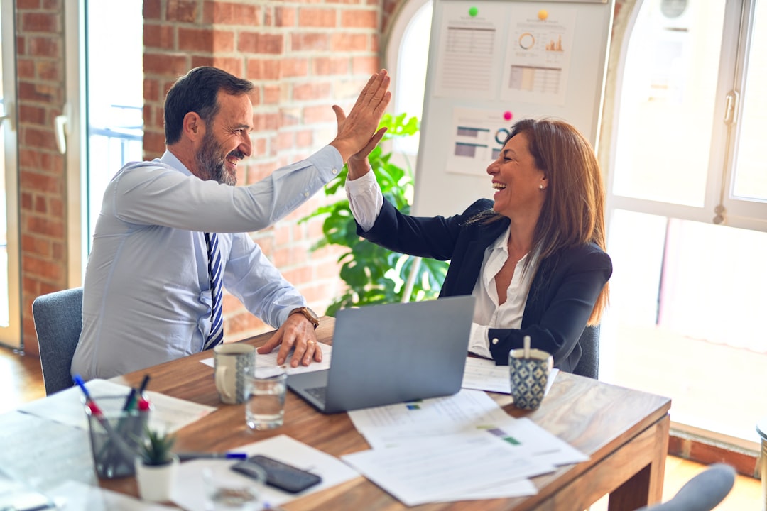 Business professionals shaking hands representing business sale transaction with commercial real estate valuation