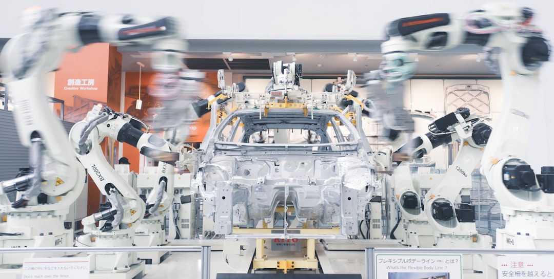 Robotic arms assembling automotive parts representing Detroit industrial property broker opinion of value